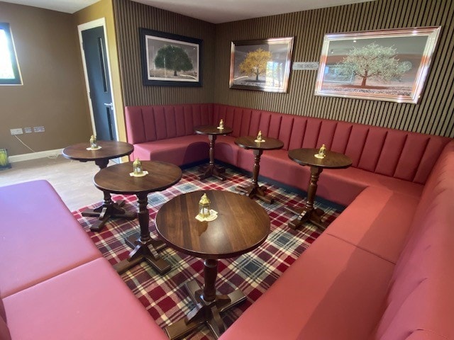 Dining room with plaid carpet, booth seating and animal artwork
