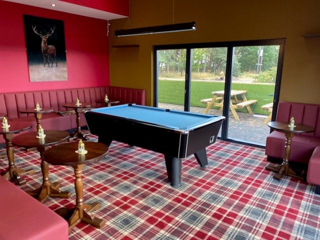 Outdoor picnic tables and play area at The Haybale